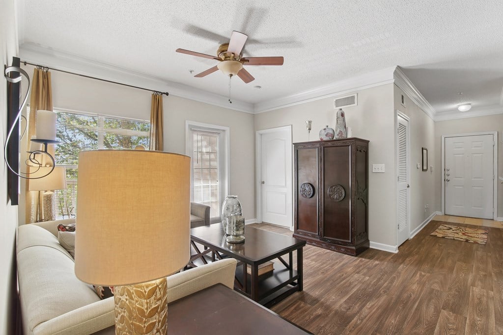 A living room with a brown table and a white sofa.