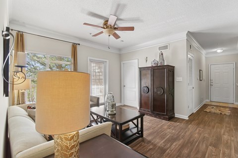 A living room with a brown table and a white sofa.