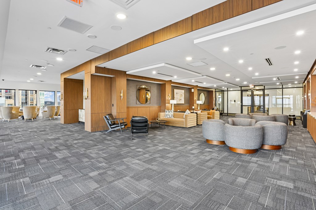 A spacious room with grey carpeting and wooden accents.