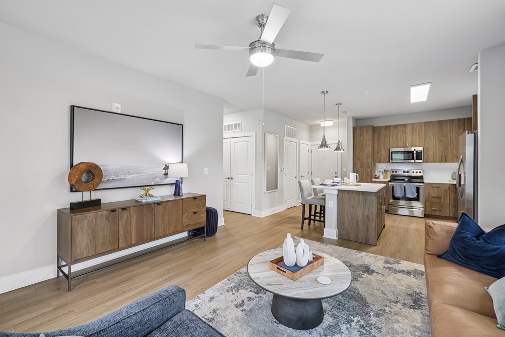 Living Area With Kitchen View at The Exchange at Crestview Apartments, Crestview, Florida