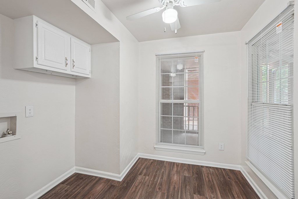 A room with a window and a fireplace.