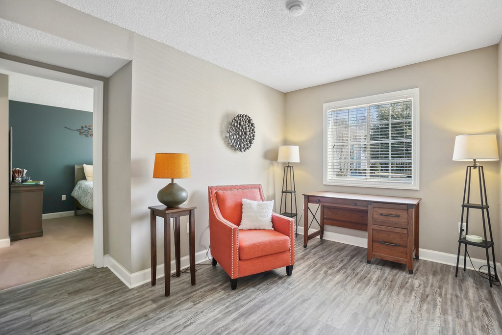 Living room with a red chair and a desk  at Cape Landing, Myrtle Beach, SC, 29588