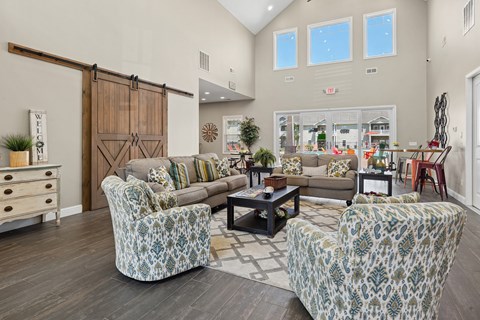 A living room with a couch, chairs, and a coffee table.