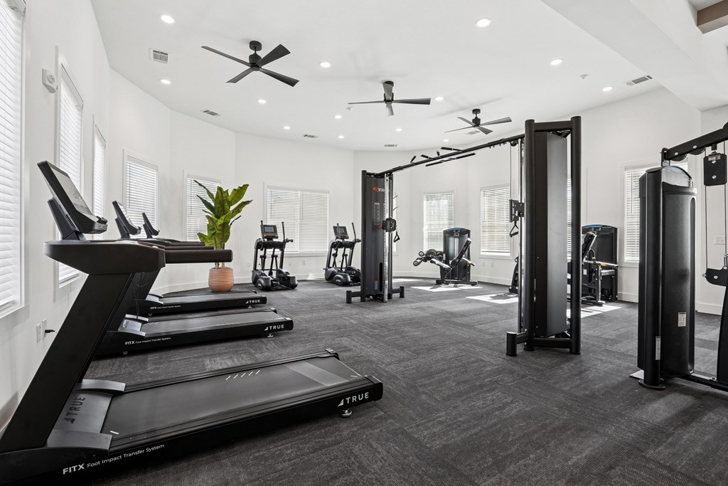 A spacious gym with treadmills, elliptical machines, and other exercise equipment.