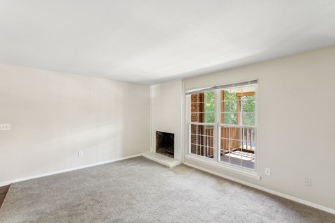 a living room with a fireplace and a large window