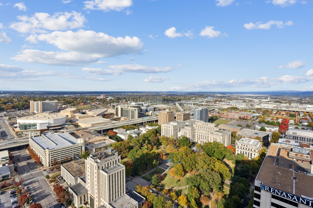 A cityscape with buildings and trees in the foreground.