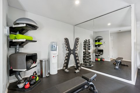 A well-equipped home gym with a variety of exercise equipment.