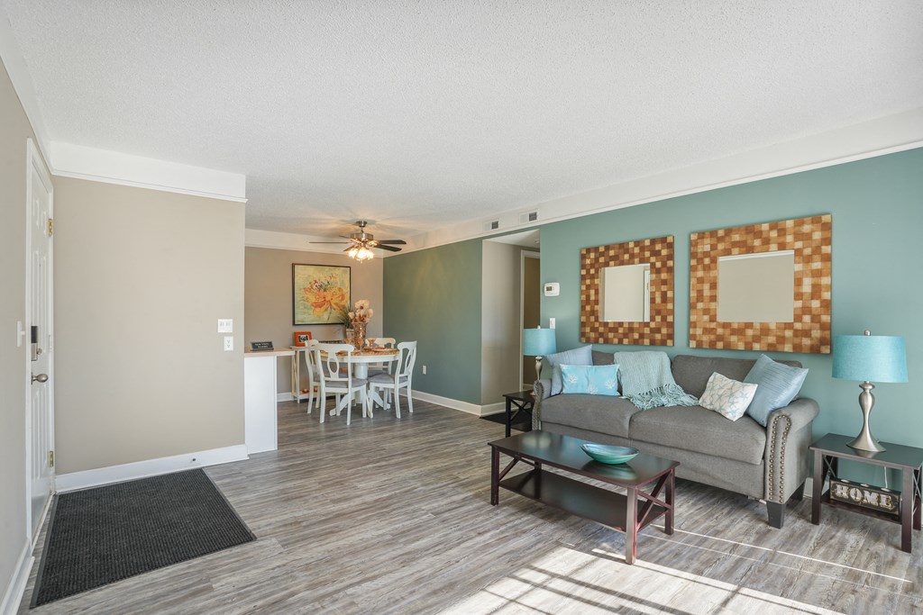 Living room and dining room with a couch and a table  at Cape Landing, Myrtle Beach, 29588