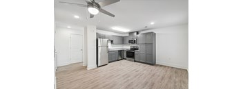 A spacious kitchen with a refrigerator, oven, and microwave at The Parker North Augusta, North Augusta, SC, 29841