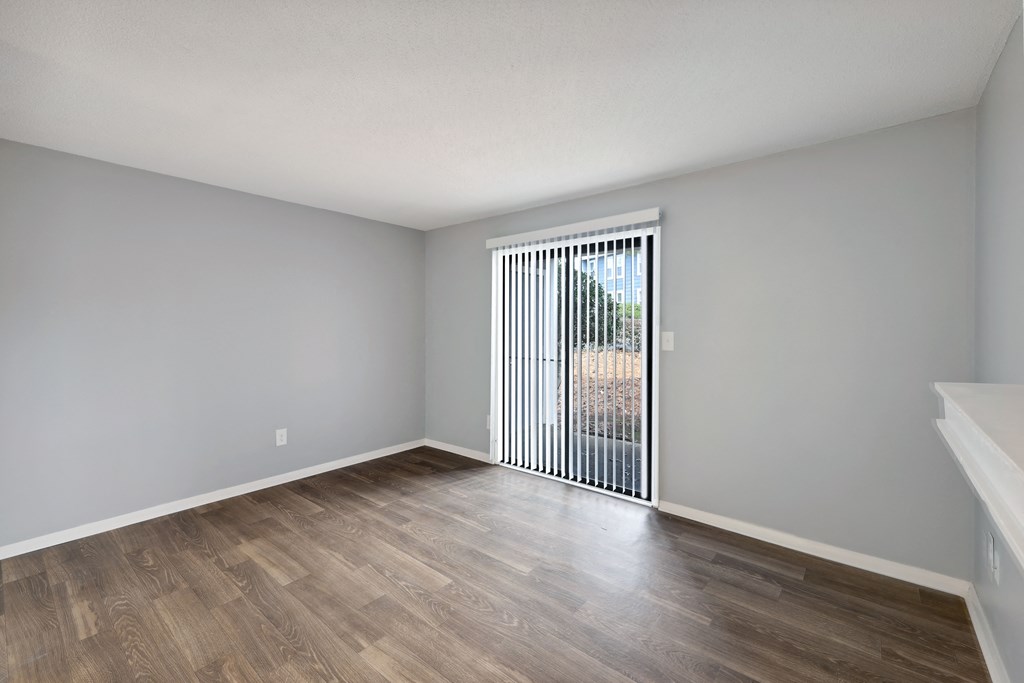 an empty living room with a sliding glass door to a patio  at Governors House, Huntsville, AL, 35805