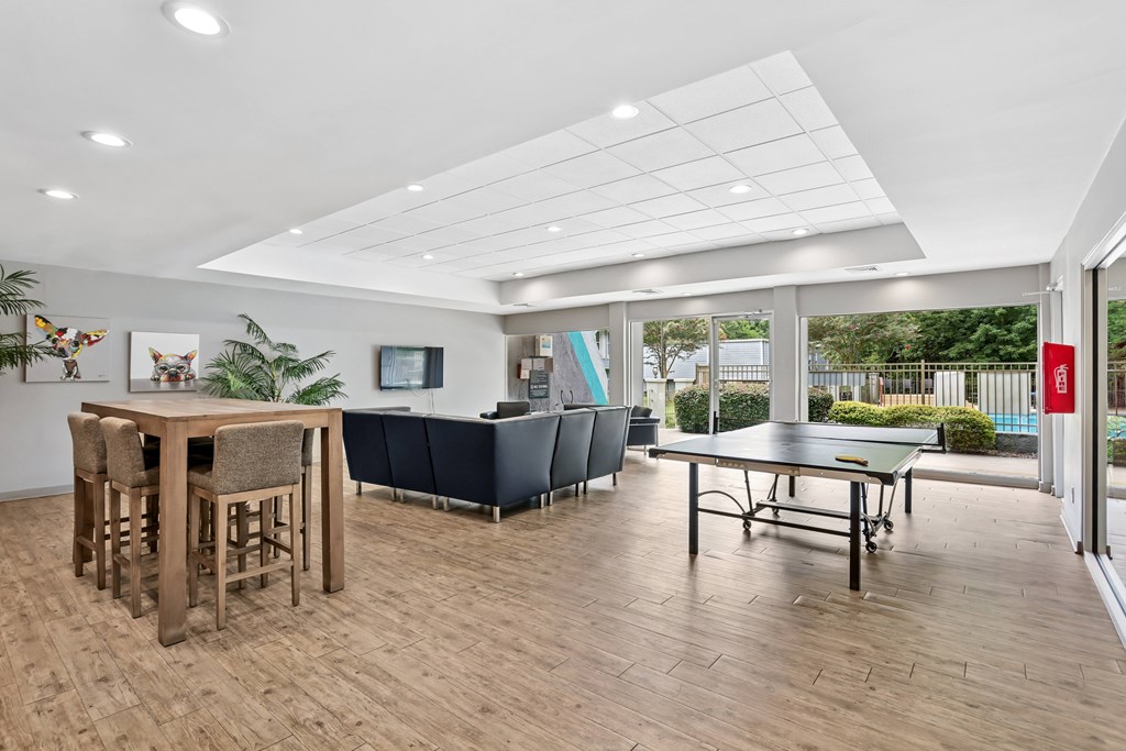 A room with a bar and a ping pong table.