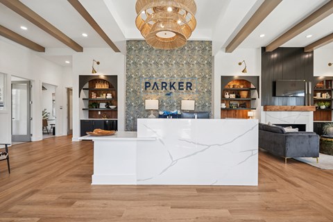 A reception area with a white counter and a sign that says "PARKER".