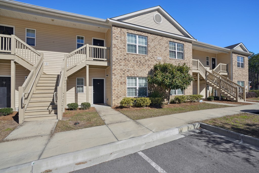 Apartment building with stairs and a sidewalk  at The Meadows, Bloomingdale, GA