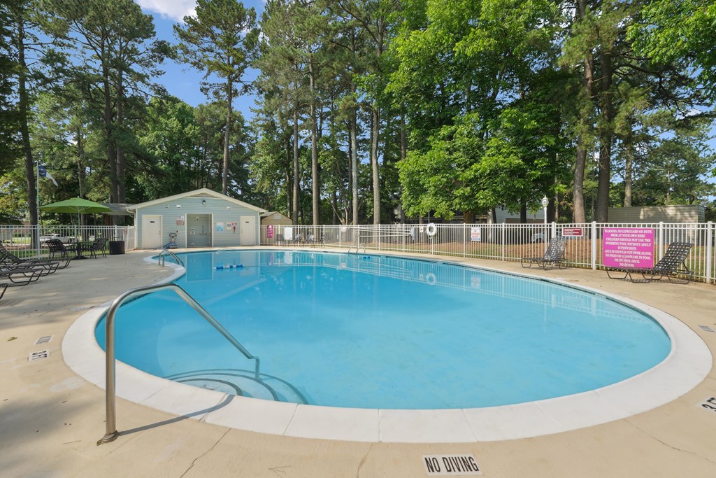 A large round pool with setting around.