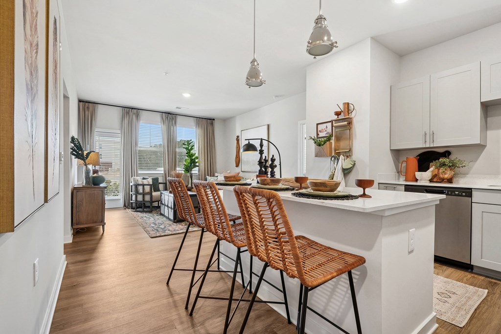 A kitchen with a long table and chairs.