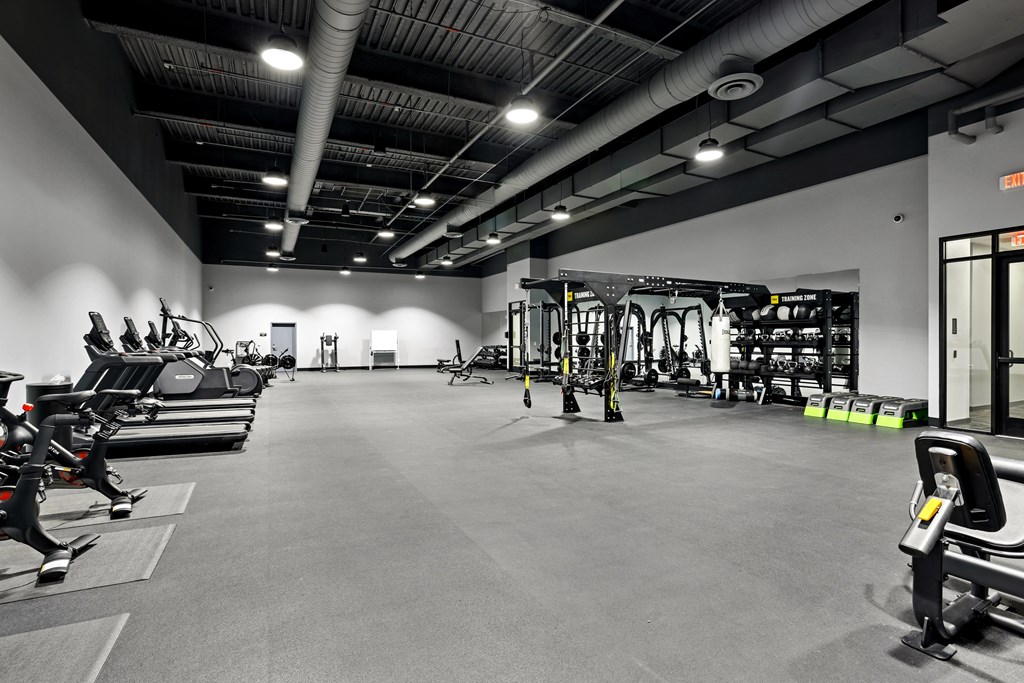 A gym with a variety of exercise equipment.