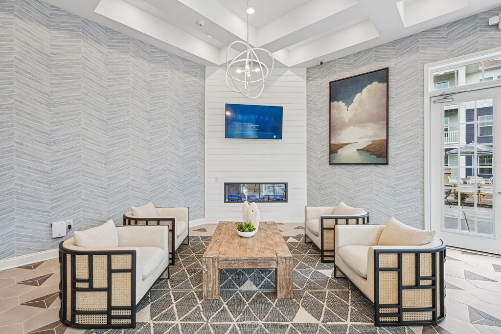 A modern living room with a fireplace and a painting on the wall.at The Parker Leland, Leland  