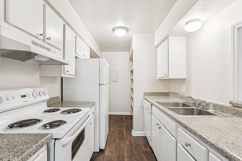 a kitchen with white appliances and counter tops