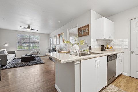 A kitchen with white cabinets and a large island.