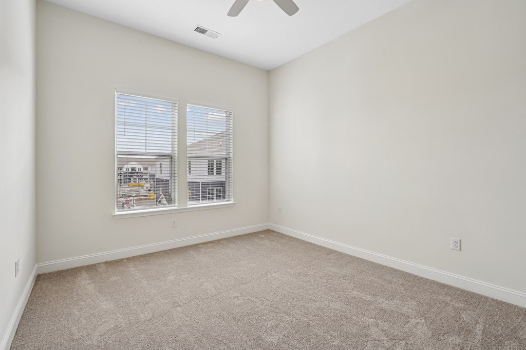 A room with a carpet floor and a ceiling fan.at The Parker Leland, North Carolina, 28451 