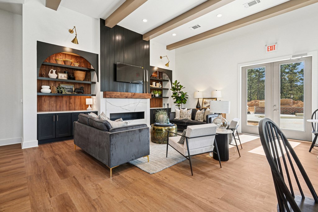 A living room with a grey couch and a white chair.