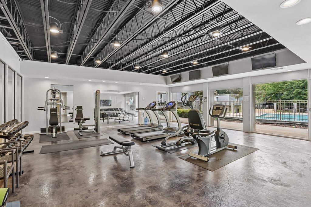 A spacious gym with a variety of equipment including treadmills, weights, and exercise machines.