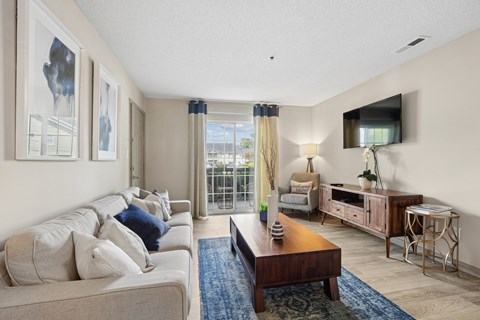 Living room with balcony and modern furnishings at Viera Aiken Apartments, Aiken, 29803