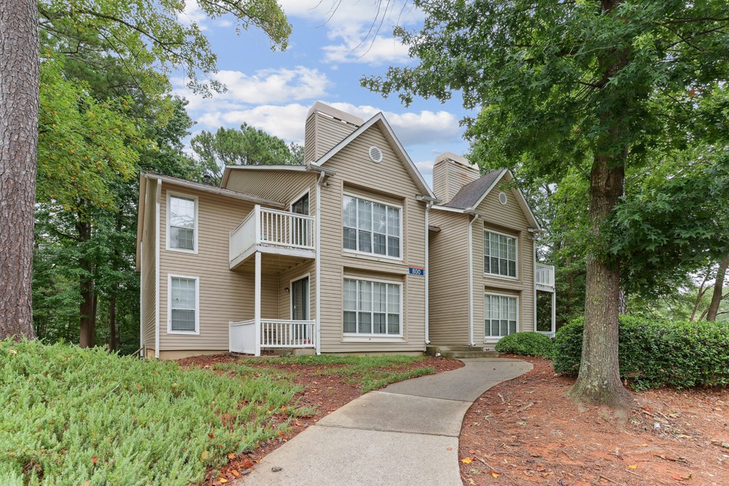 A two-story house with a balcony on the second floor.