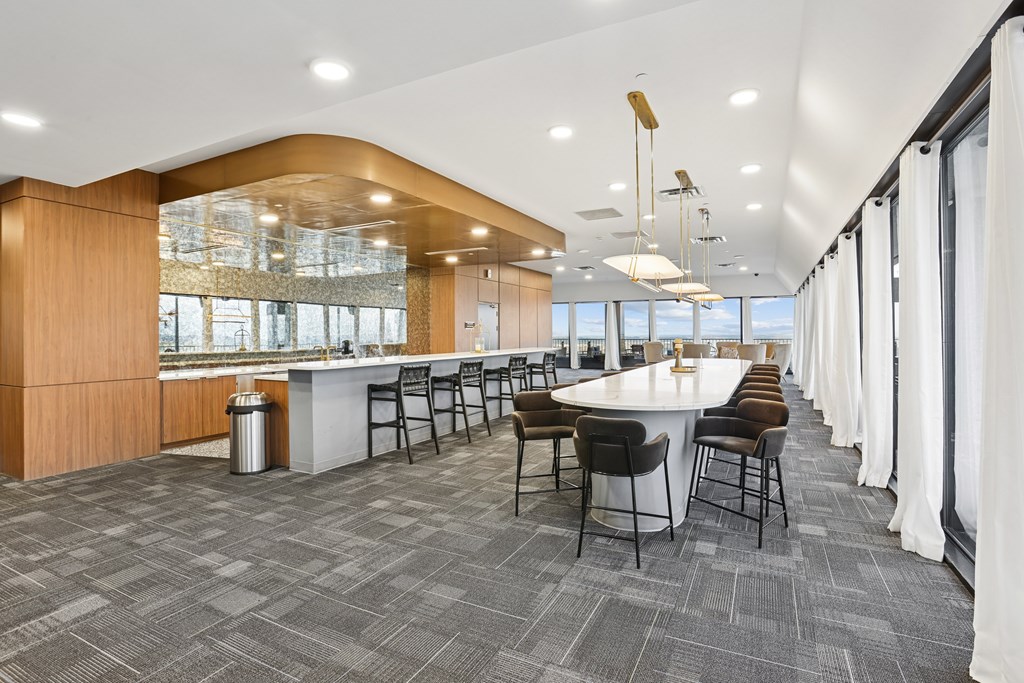 A modern dining area with a long table and chairs.