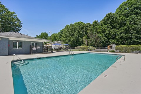 Sparkling swimming pool with patio seating area at Greenbryre Apartments, Charlotte