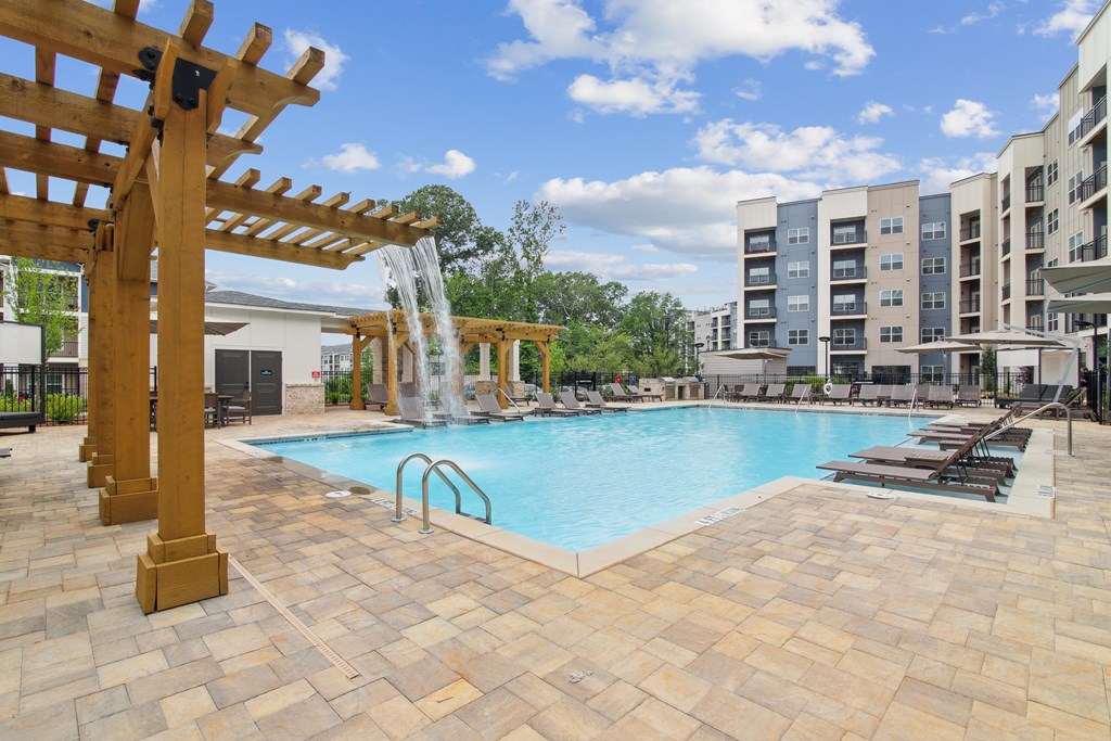 Pool With Relaxing Chairs at The Delaney at East Park Apartments, Kennesaw, Georgia