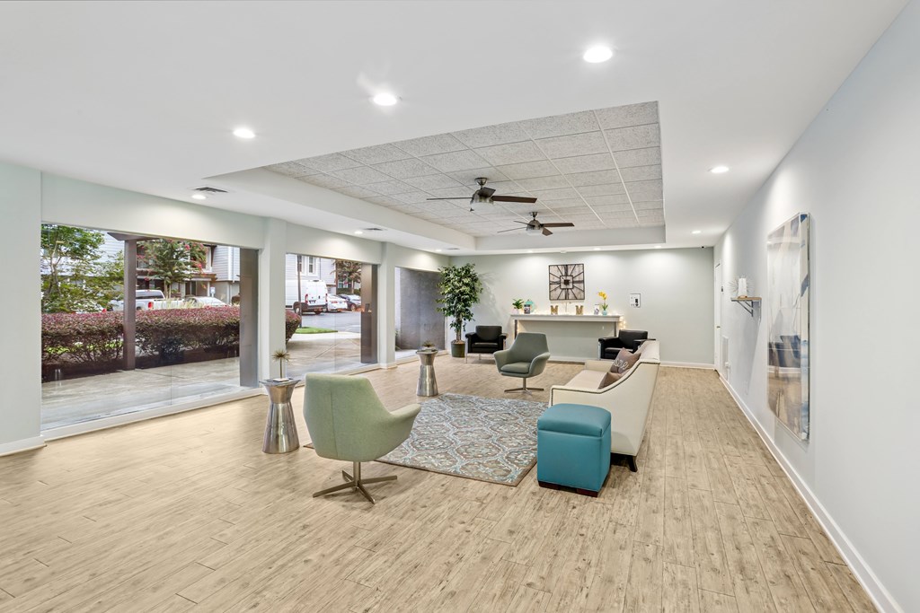 A spacious room with a green chair and a blue ottoman.
