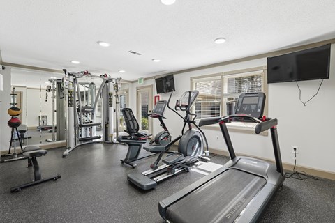 Fitness center with cardio and strength equipment at Emory Woods Apartments, Durham, 27713