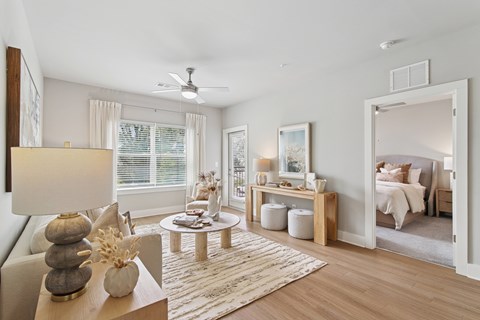 A well-lit, spacious bedroom with a large bed and a cozy seating area.