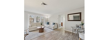 A living room with a white couch and a coffee table.