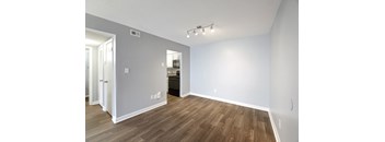A room with wooden flooring and white walls.