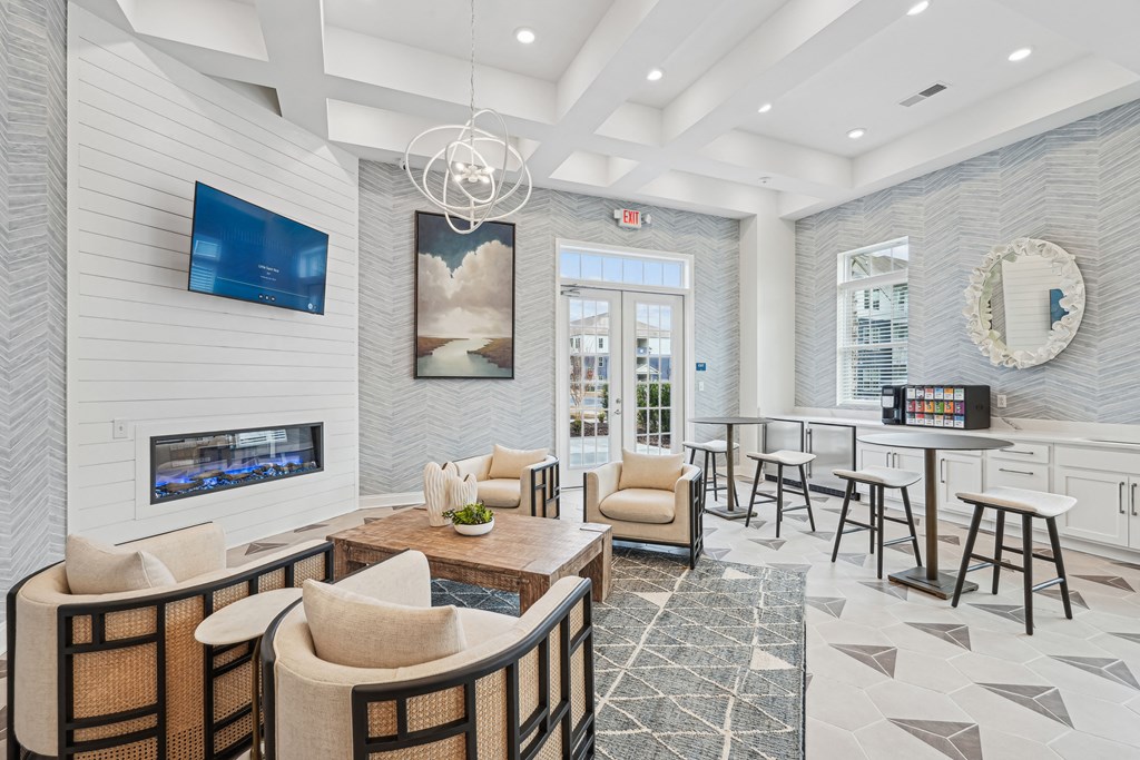 A modern living room with a fireplace and a flat screen TV.at The Parker Leland, Leland North Carolina  