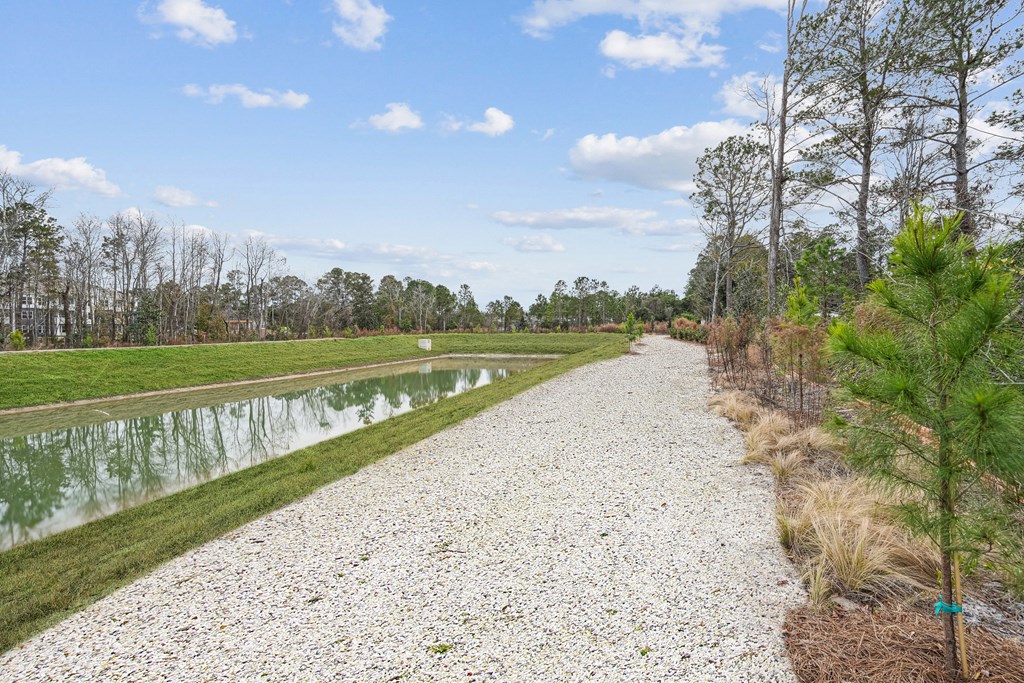 A gravel path runs alongside a body of water.at The Parker Leland, Leland, NC  