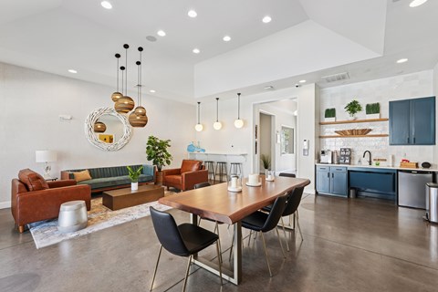 A modern living room with a dining table and chairs.