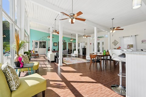 A sunny day in a spacious living room with a yellow sofa and a dining table.