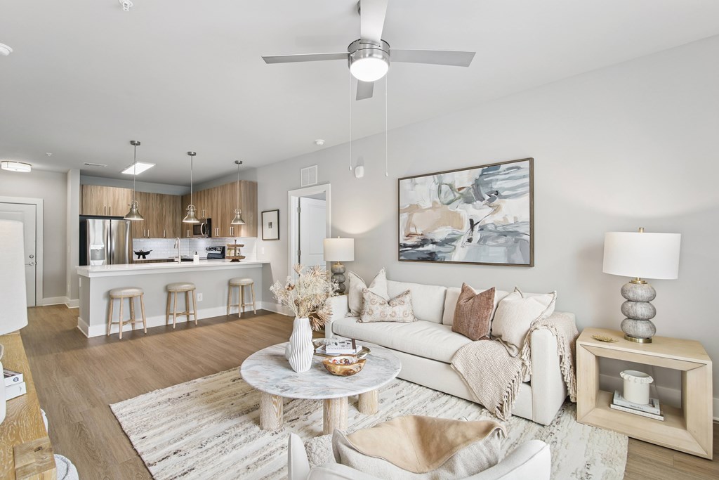 Living Area With Kitchen at The Delaney at East Park Apartments, Kennesaw, Georgia