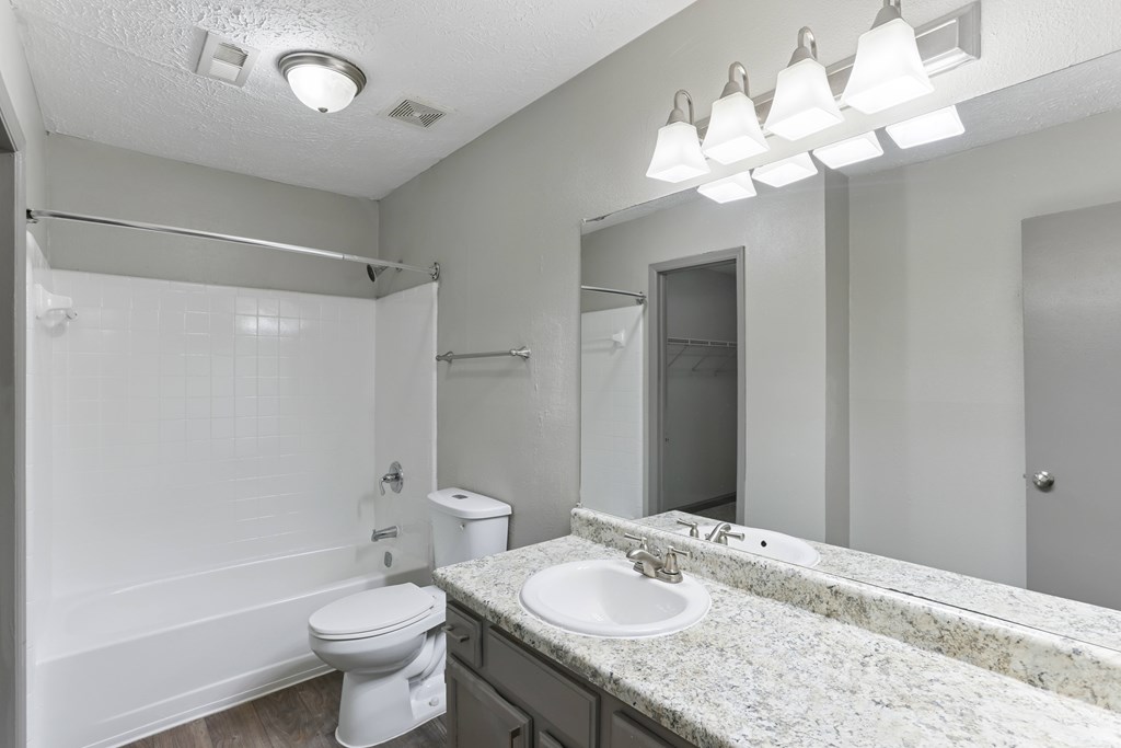 A white toilet sits next to a sink in a bathroom.