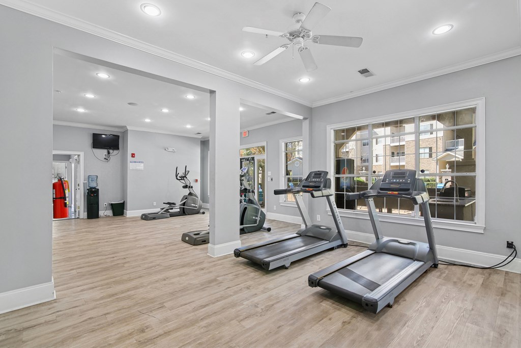 A spacious gym with treadmills and exercise equipment.