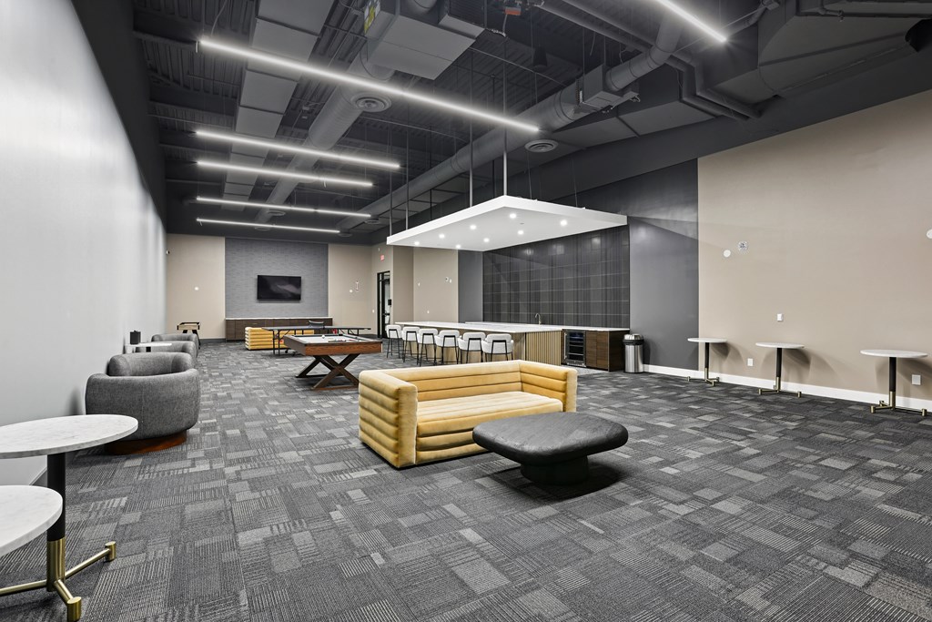 A modern office space with grey carpeting and wooden furniture.