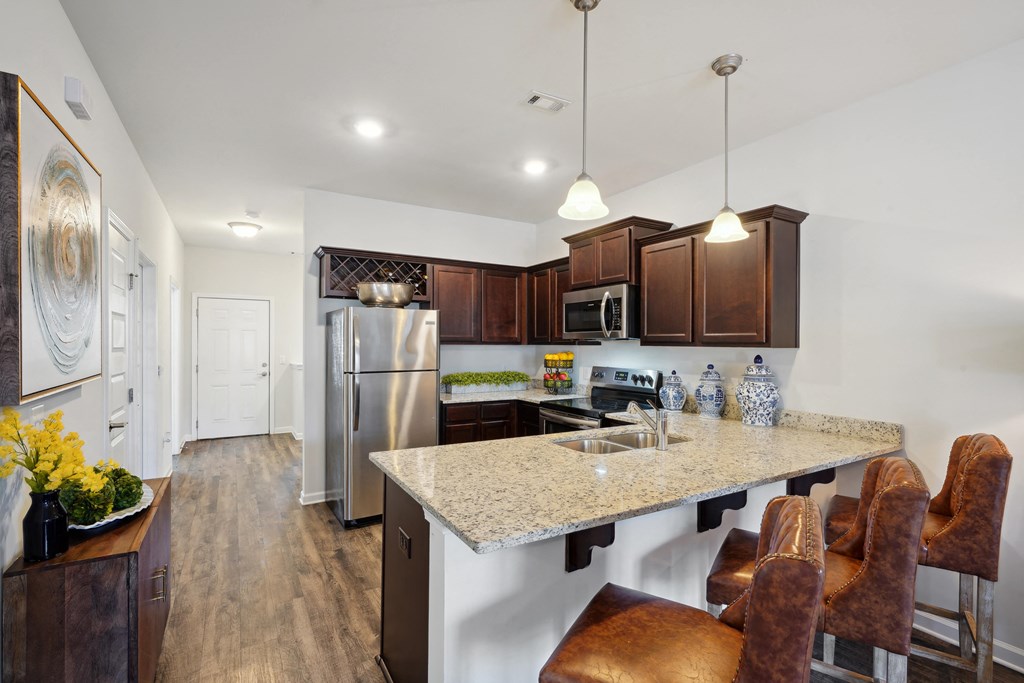Kitchen with stainless steel appliances and a granite counter top at The Meadows, Bloomingdale, GA, 31302
