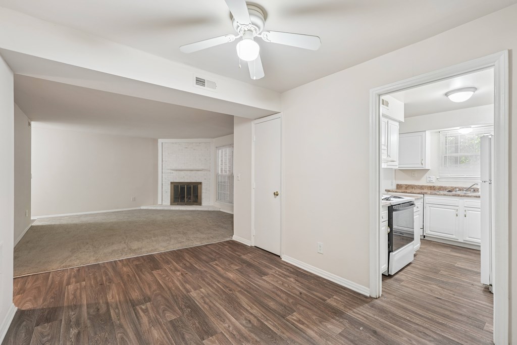 A room with a fireplace and a ceiling fan.