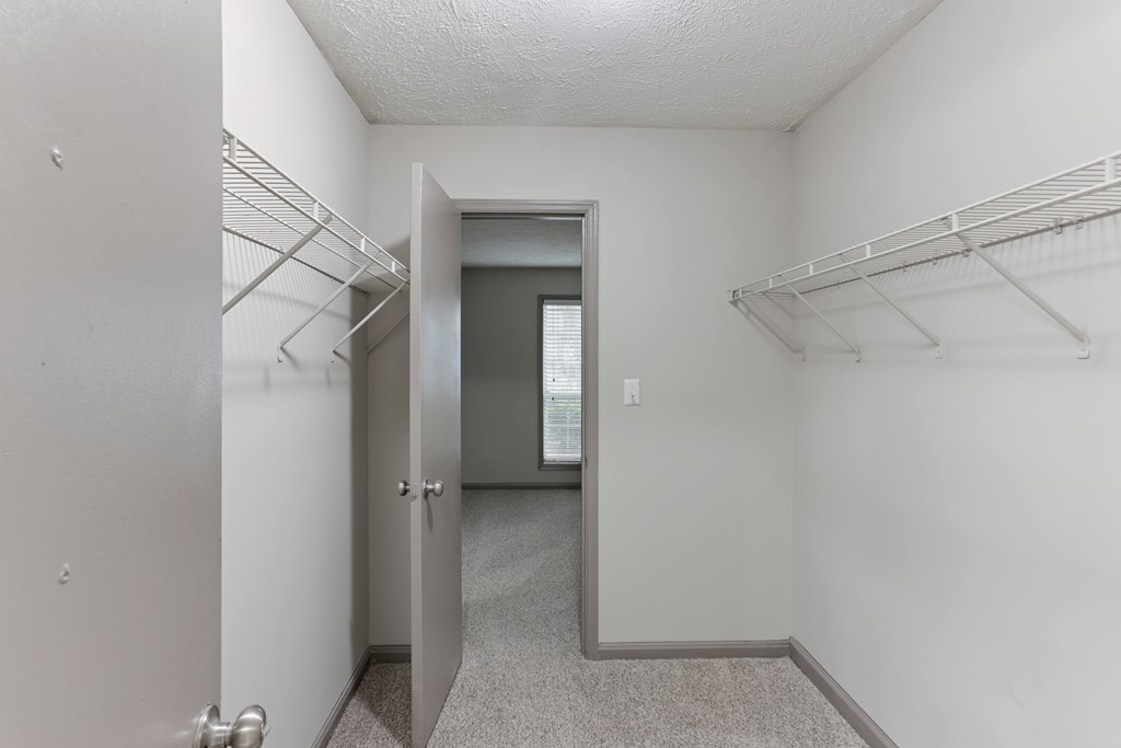 A hallway with a door on the left and a door on the right.