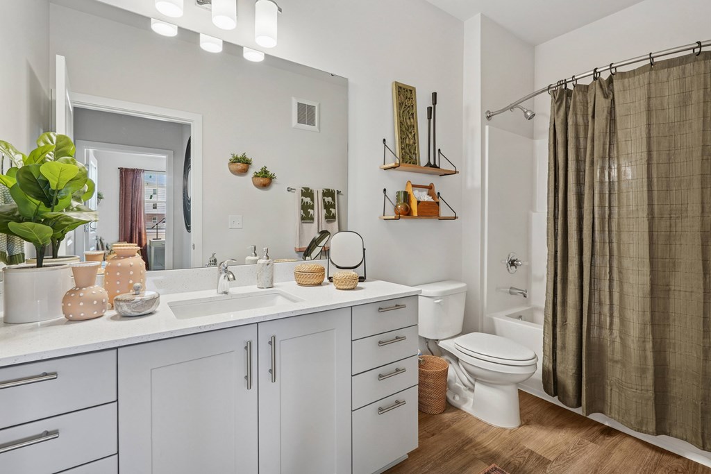 A bathroom with a white sink and a white toilet.