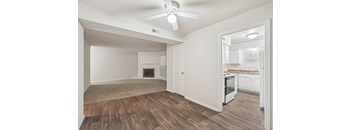 A room with a fireplace and a ceiling fan.