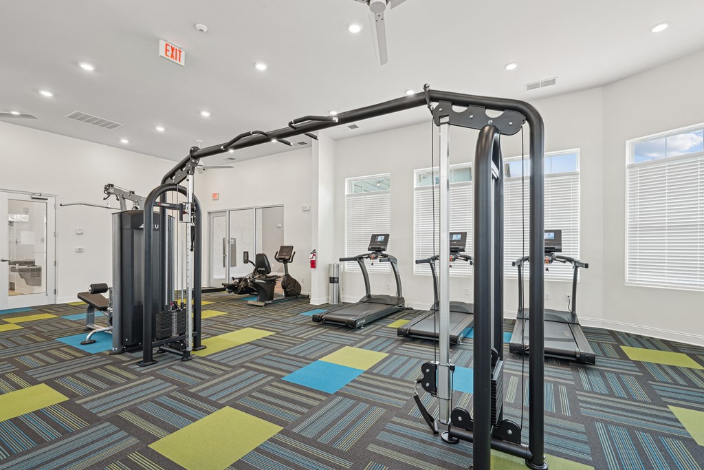 A gym with a variety of equipment including treadmills and weight machines.at The Parker Leland, North Carolina, 28451 